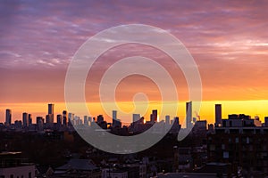 Downtown Toronto skyline at sunrise, with golden light illuminating the sky and sides of buildings