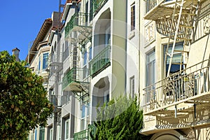 Downtown urban apartment building comple with decorative front facades and white exteriors with windows and balconies