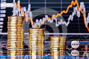 Downtrend financial chart, stacks of golden coins and dices cube photo