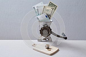 Downturn and bank or financial crisis. Inflation and depreciation money concept. Grinder grinding banknotes into coins