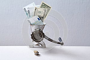 Downturn and bank or financial crisis. Inflation and depreciation money concept. Grinder grinding banknotes into coins.
