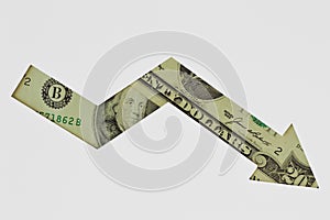 Downward arrow made of dollar banknotes on white background - Concept of downward trend of dollar currency