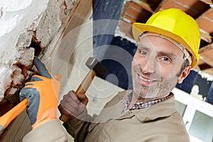 Downward view builder holding sledge hammer