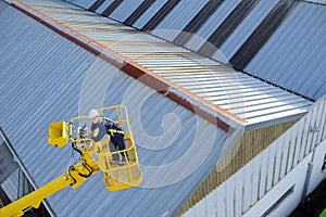 Downward view woman in cherry picker bucket