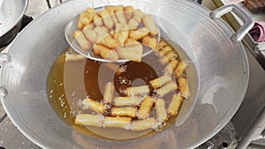 Dozens of crispy deep-fried spring roll in cooking oil