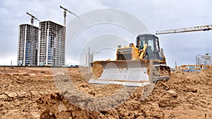 Dozer in action at construction site. Bulldozer for land clearing, demolition, pool excavation, utility trenching and foundation