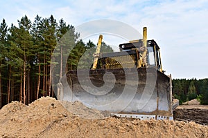 Dozer during clearing forest for construction new road