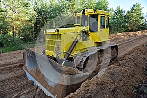 Dozer during clearing forest for construction new road. Bulldozer at forestry work Earth-moving equipment at road work, land