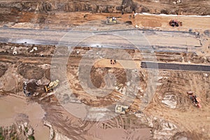 Dozer levels the ground during road construction, aerial view. Compaction of soil for laying asphalt at a construction site. The
