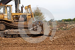 Dozer working at construction site. Bulldozer for land clearing, grading, utility trenching and foundation digging. Crawler