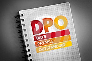 DPO - Days Payable Outstanding acronym on notepad, business concept background
