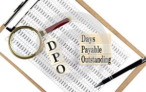 DPO - Days Payable Outstanding text on wooden block on chart background