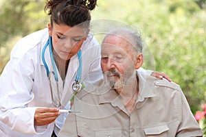 Dr reading thermometer of senior man