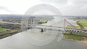 Dr. W. Hupkesbrug and Martinus Nijhoffbrug aerial drone view highway infrastructure bridge over a large waterway in The