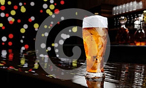 Draft or craft beer in tall clear glass. With cold steam, White beer foam placed on a wooden floor, behind the background is a
