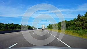Drafting Large Truck on Highway During Summer Day.  Driver Point of View POV Slipstreaming by Following Vehicle on Interstate