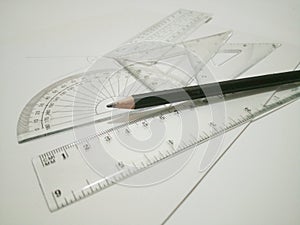 Drafting tools and pencil are on white background