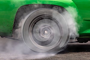 Drag car burning tire, Warm up tire before competition, Drag car wheel, Spinning wheel and smoke, Drag racing car burns rubber