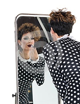 Drag Queen use Lipstick near Mirror