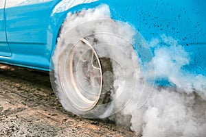 Drag racing car burn tire in preparation for the race