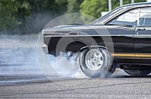 Drag racing car burns rubber