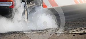 Drag racing car burns tires preparation for the race