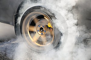 Drag racing car burns tires for the race