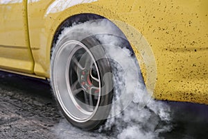 Drag racing car burns tires for the race