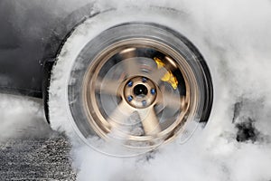Drag racing car burns tire in preparation for the race