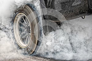 Drag racing car burns tire for the race