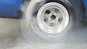 Drag racing car burns tires for the race