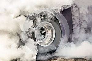 Drag racing car burns tires for the race