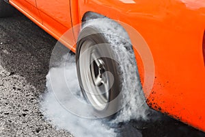 Drag racing car burns tires for the race