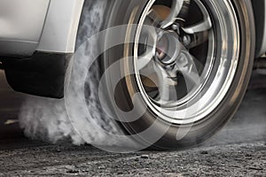 Drag racing car burns tires for the race