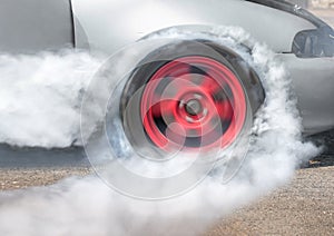 Drag racing car burns tires for the race