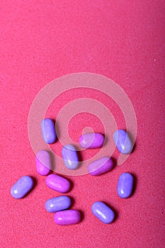 Dragee for refreshment of breath. Among on a coral background