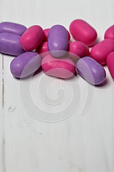 Dragee for refreshment of breath. Different color. Lying on a white surface