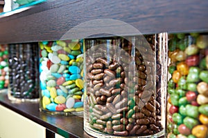 Dragee sweets in chocolate and icing on store