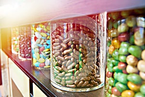 Dragee sweets in chocolate and icing on store