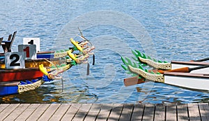 Dragon boats moored at wooden jetty