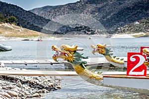 Dragon boats moored at wooden pier or jetty on the lake