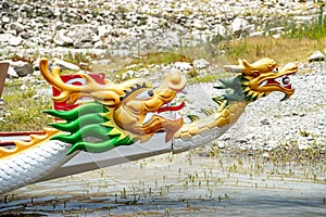 Dragon boats moored at wooden pier or jetty on the lake