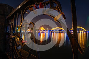 Dragon Bridge Da Nang framed by padlocks locked on the near by Love Bridge