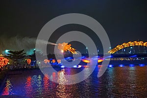 Dragon bridge in Da Nang, Vietnam, at night. The dragon blowing hot fire out of its mouth. A famous attraction in Da Nang