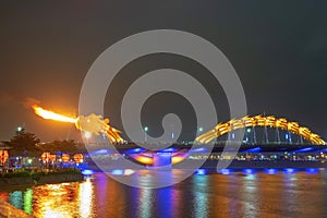 Dragon bridge in Da Nang, Vietnam, at night. The dragon blowing hot fire out of its mouth. A famous attraction in Da Nang