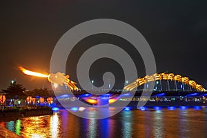 Dragon bridge in Da Nang, Vietnam, at night. The dragon blowing hot fire out of its mouth. A famous attraction in Da Nang