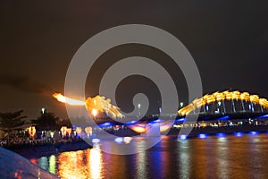 Dragon bridge in Da Nang, Vietnam, at night. The dragon blowing hot fire out of its mouth. A famous attraction in Da Nang