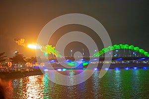 Dragon bridge in Da Nang, Vietnam, at night. The dragon blowing hot fire out of its mouth. A famous attraction in Da Nang