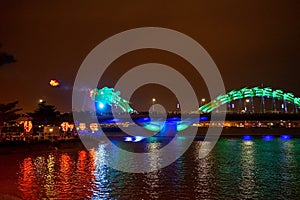 Dragon bridge in Da Nang, Vietnam, at night. The dragon blowing hot fire out of its mouth. A famous attraction in Da Nang