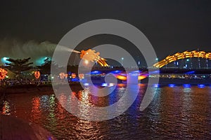 Dragon bridge in Da Nang, Vietnam, at night. The dragon blowing hot fire out of its mouth. A famous attraction in Da Nang